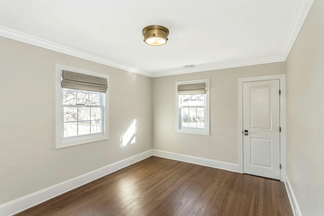 unfurnished room featuring a wealth of natural light, dark hardwood / wood-style flooring, and ornamental molding