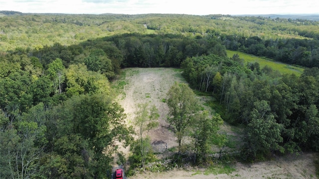 bird's eye view featuring a wooded view