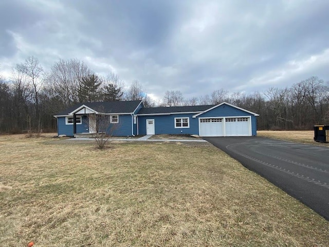 single story home featuring a garage and a front lawn