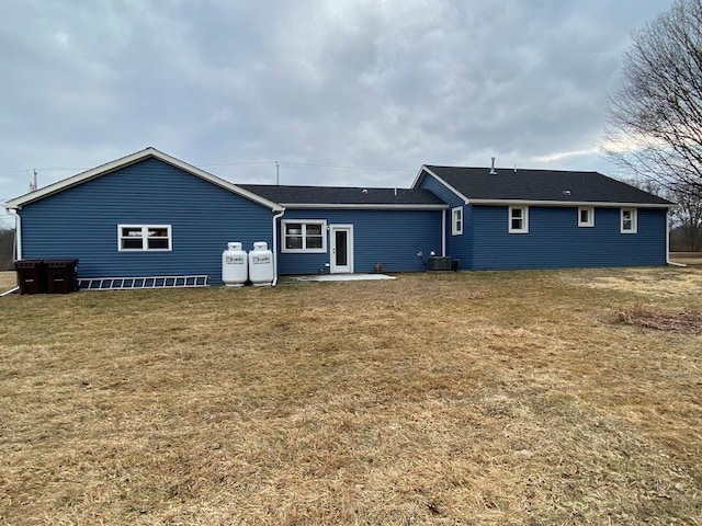 back of property featuring a patio, cooling unit, and a lawn