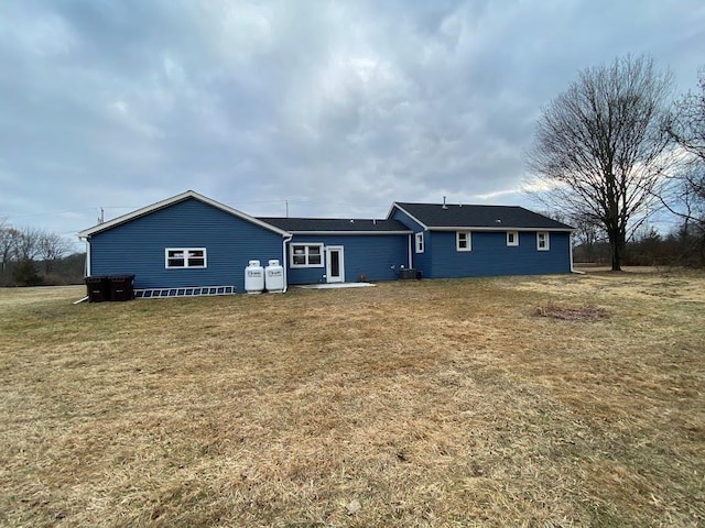 rear view of property featuring a yard