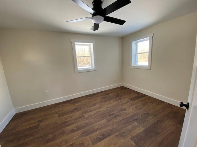 unfurnished room with dark hardwood / wood-style floors and ceiling fan