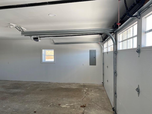 garage with a garage door opener and electric panel