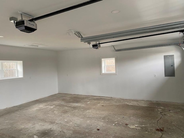 garage featuring a garage door opener and electric panel