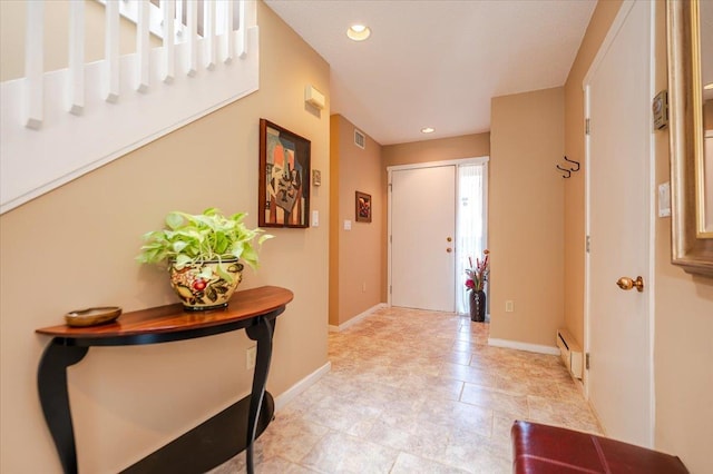 entrance foyer with baseboards, visible vents, a baseboard heating unit, and recessed lighting