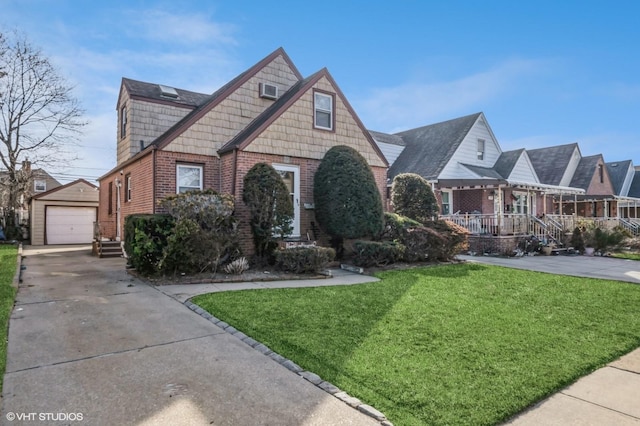 view of front of house with an outbuilding, a front yard, and a garage