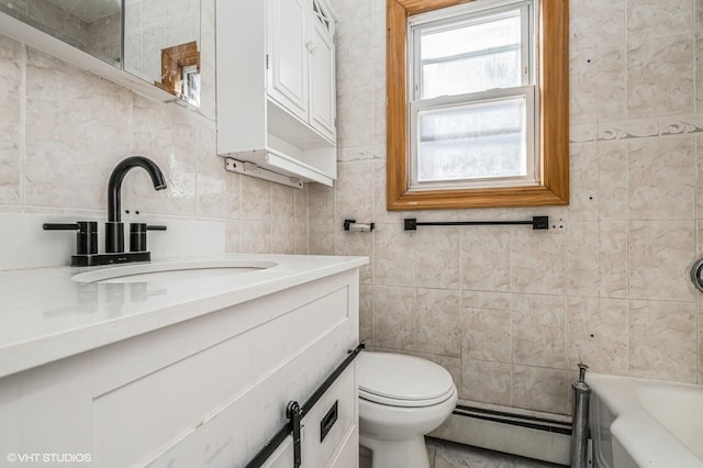 bathroom featuring tile walls, vanity, a bathtub, toilet, and a baseboard radiator