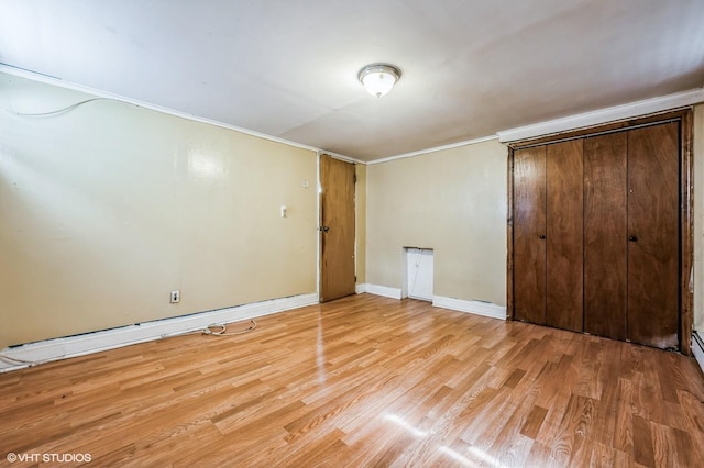 unfurnished bedroom featuring light hardwood / wood-style flooring and a closet