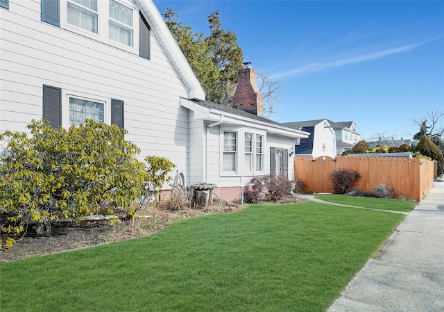 view of property exterior with a yard