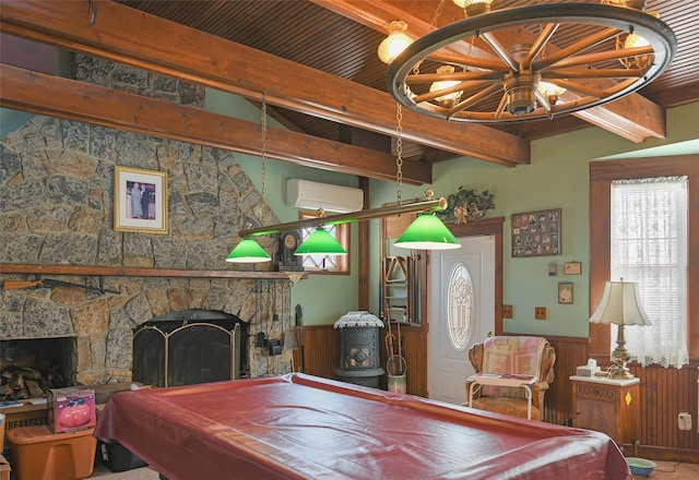 playroom with billiards, a stone fireplace, a wall mounted air conditioner, wooden walls, and beam ceiling