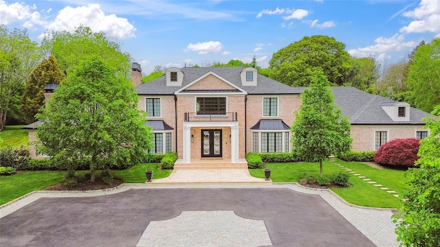 25 Longridge Ln, Old Brookville, NY 11545 - georgian-style home featuring french doors, brick siding, a front lawn, and a chimney