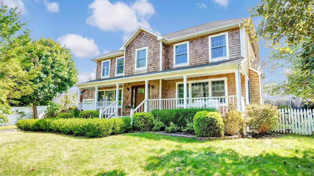 16 Clay Pit Rd, Remsenburg, NY 11960 - view of front of property featuring covered porch and a front lawn