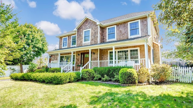 view of front of property featuring covered porch and a front lawn