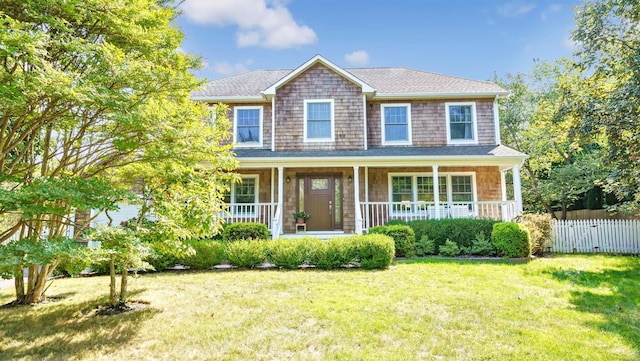 view of front of home with a front yard and a porch