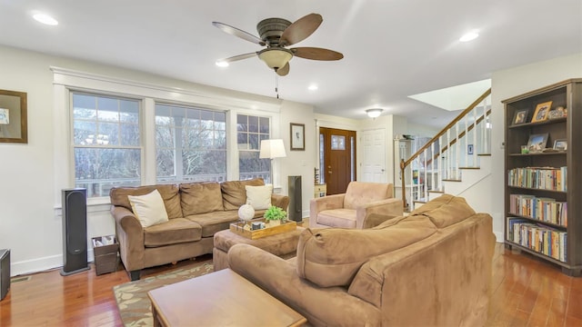 living room featuring wood-type flooring and ceiling fan