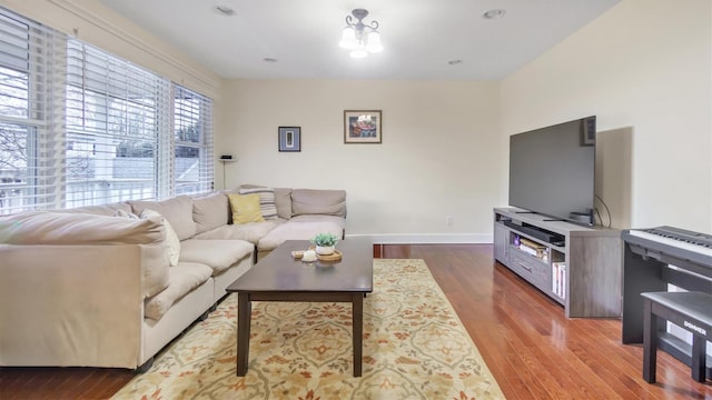 living room featuring a chandelier and dark hardwood / wood-style flooring