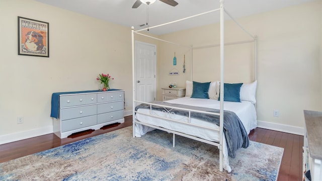 bedroom with dark hardwood / wood-style floors and ceiling fan