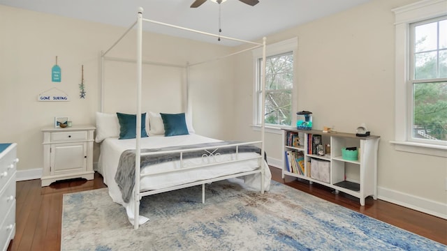 bedroom with dark hardwood / wood-style floors and ceiling fan