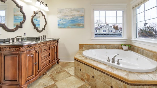 bathroom featuring a relaxing tiled tub and vanity