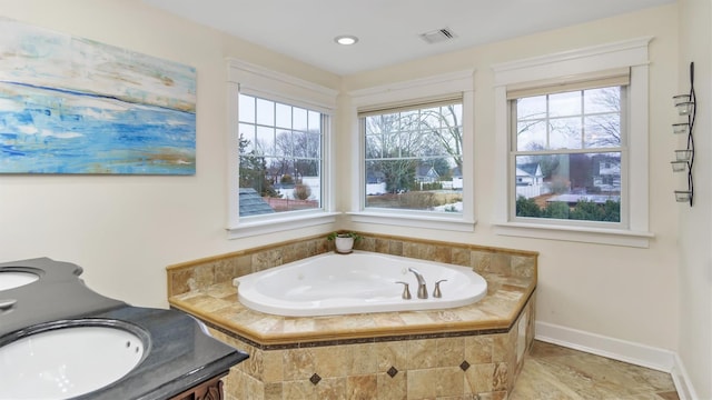 bathroom featuring sink and tiled tub