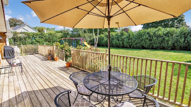 deck featuring a lawn and a playground