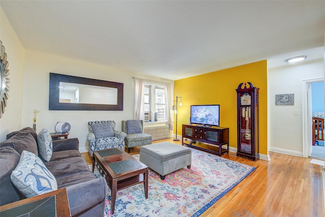 living room with hardwood / wood-style floors and radiator heating unit