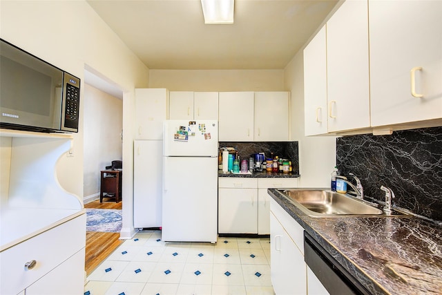 kitchen with sink, white refrigerator, dishwasher, decorative backsplash, and white cabinets