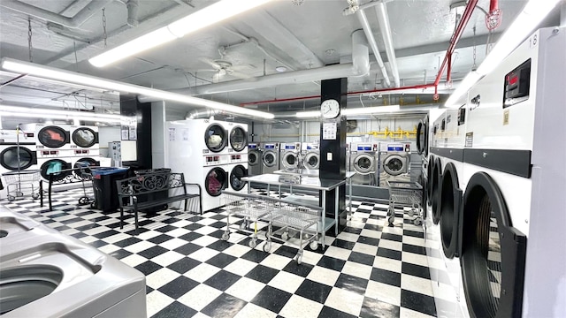 laundry room featuring stacked washer and dryer and washing machine and clothes dryer