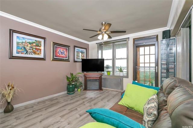 living room with crown molding, ceiling fan, and light hardwood / wood-style flooring