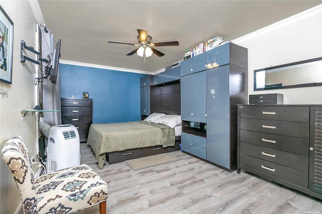 bedroom with ceiling fan, ornamental molding, and light wood-type flooring