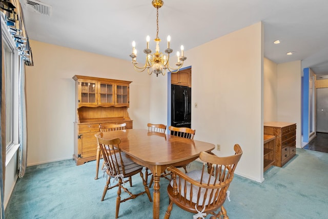 dining space featuring light carpet and a notable chandelier