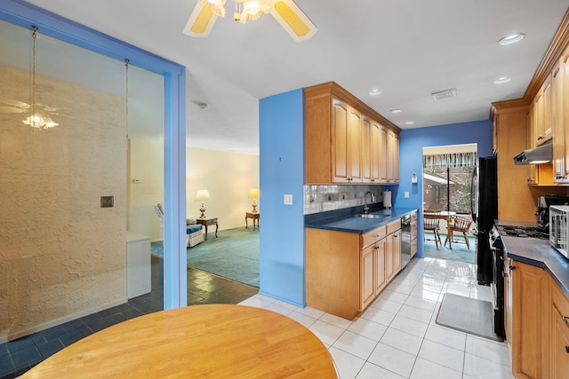 kitchen featuring sink, light tile patterned floors, dishwasher, decorative backsplash, and gas range