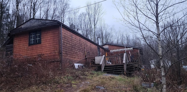 view of property exterior featuring a wooden deck