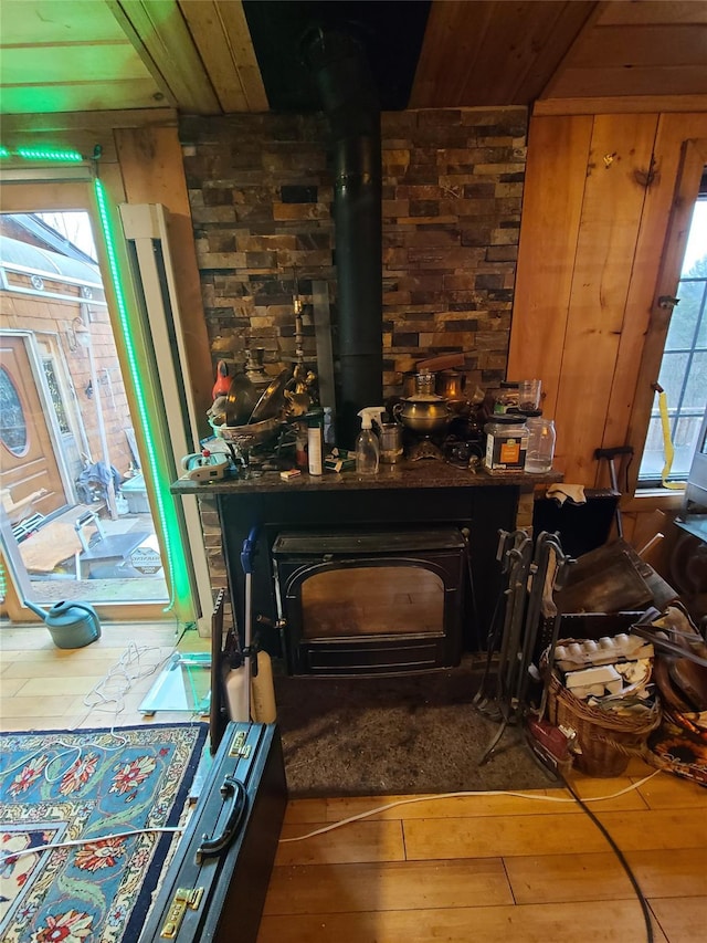 interior details featuring wood finished floors and a wood stove