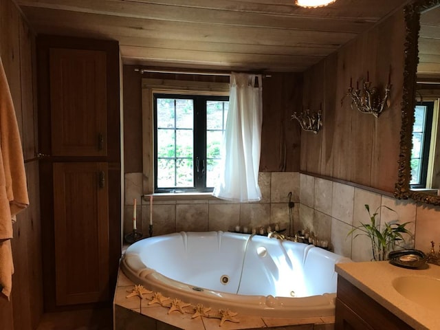 full bath featuring wooden ceiling, a tub with jets, and vanity