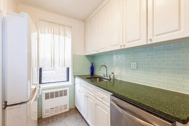 kitchen featuring radiator, sink, white cabinetry, dark stone countertops, and stainless steel dishwasher