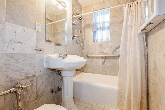 bathroom with shower / bathtub combination with curtain, tile walls, and toilet