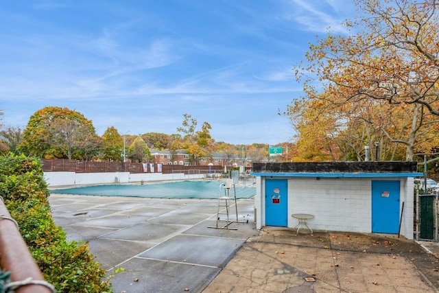 view of pool with tennis court