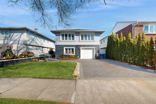 view of front of property with stone siding, stucco siding, an attached garage, decorative driveway, and a front yard