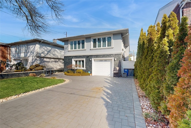 view of front facade with an attached garage, stone siding, decorative driveway, and stucco siding