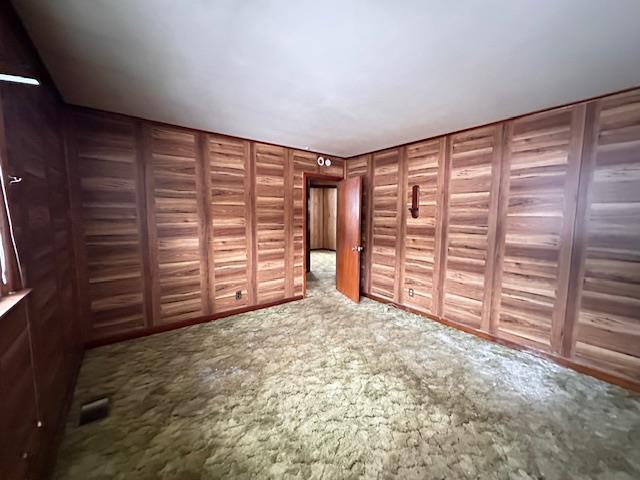 unfurnished bedroom with carpet and visible vents