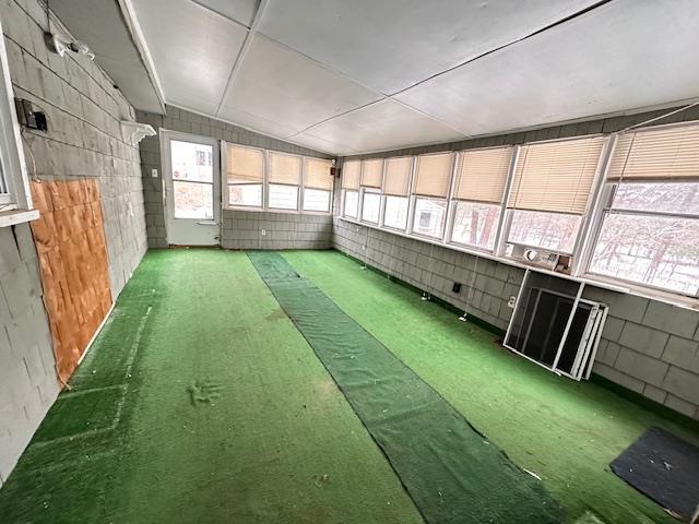 unfurnished sunroom with lofted ceiling