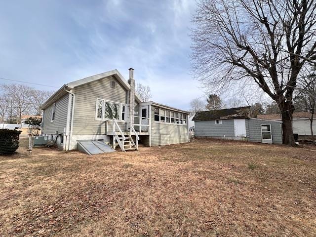 rear view of property with a yard