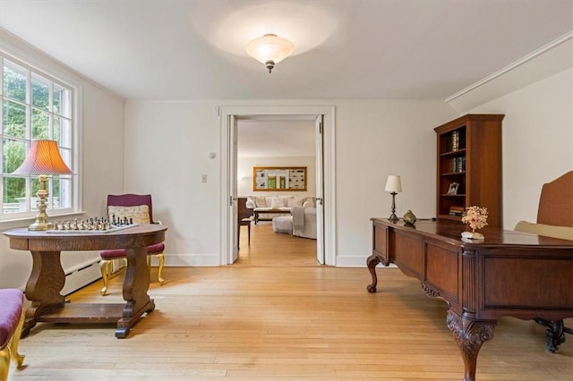 living area featuring crown molding, light wood finished floors, a baseboard radiator, and baseboards