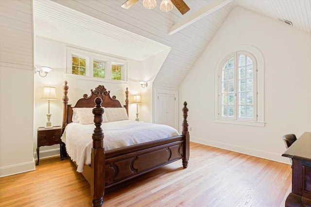 bedroom featuring light wood-type flooring, baseboards, and lofted ceiling