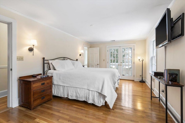 bedroom with french doors, light wood-style floors, ornamental molding, access to outside, and baseboards