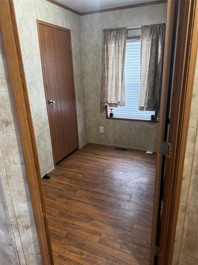 unfurnished bedroom featuring visible vents and wood finished floors