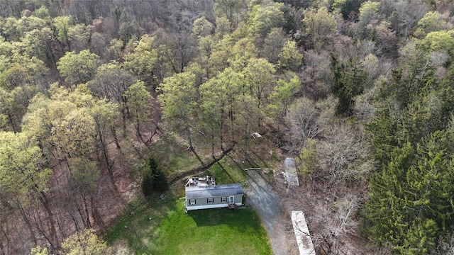 drone / aerial view with a wooded view