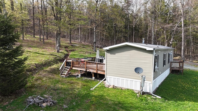 view of outbuilding featuring stairs and a view of trees