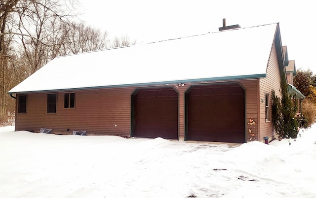 view of snow covered garage